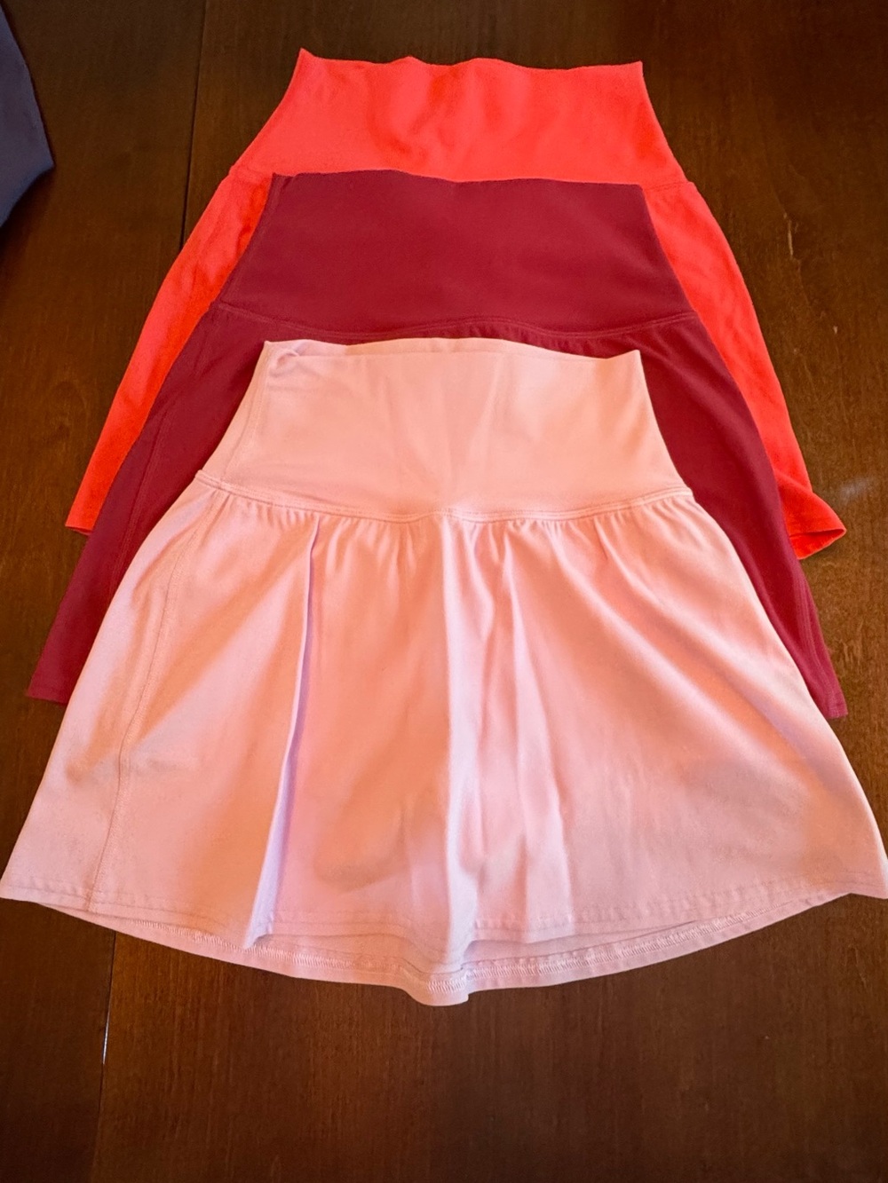 Lululemon 3-Pack Mini Skirts in Coral, Burgundy, and Light Pink